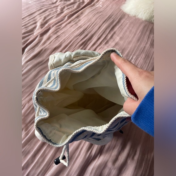 Striped blue and cream backpack with small zip pocket in front. - Picture 5 of 6